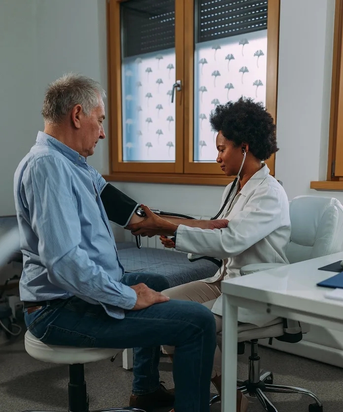 Doctor checking patient blood pressure