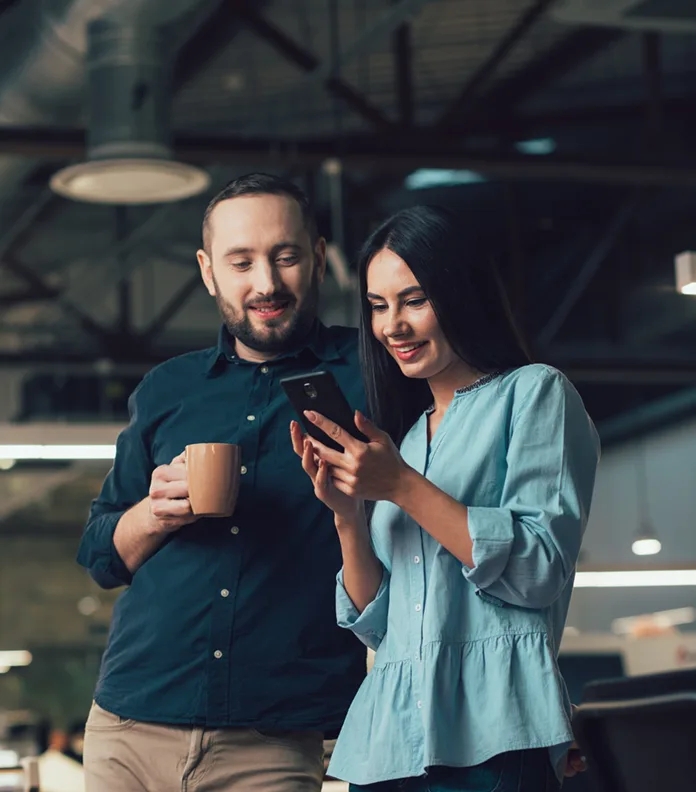 Couple looking at a mobile phone screen together