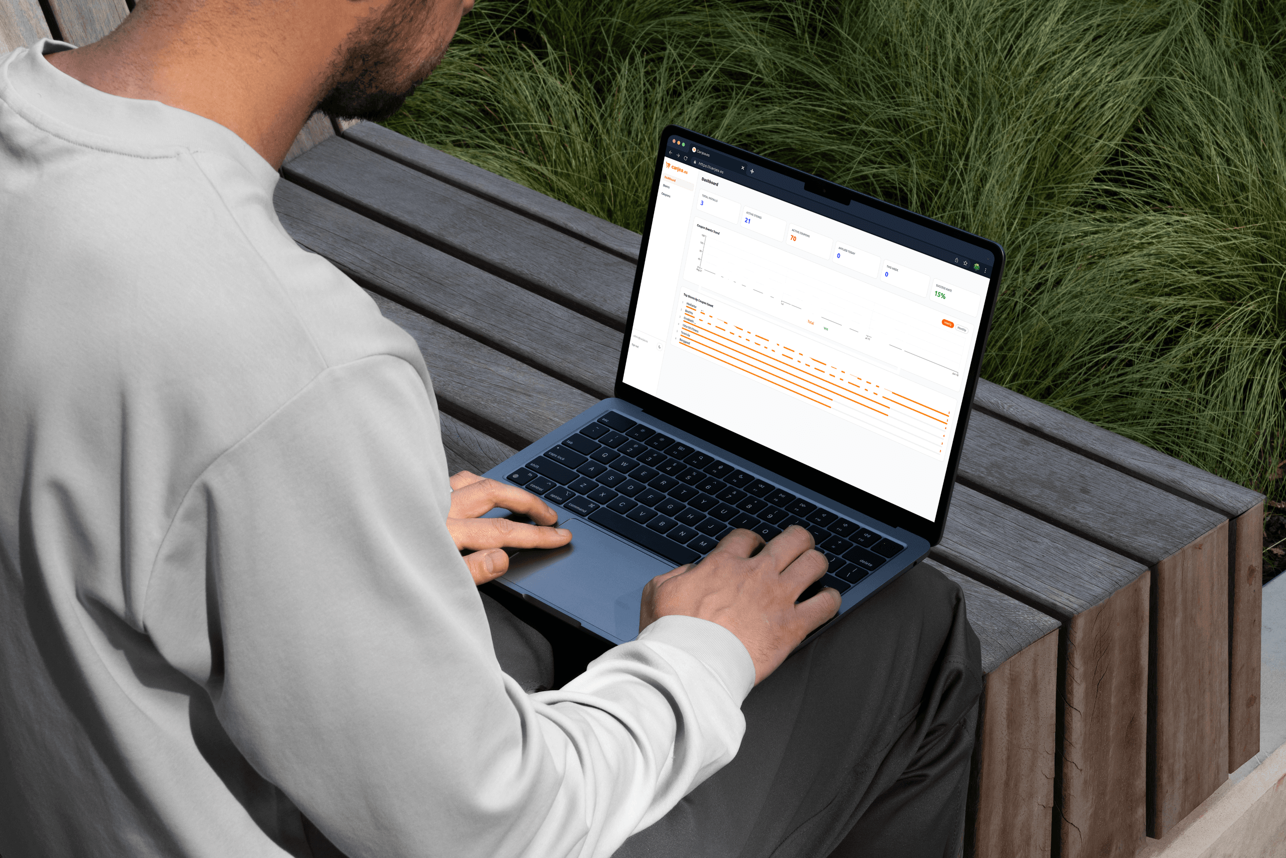 Laptop on wooden bench showing graph data