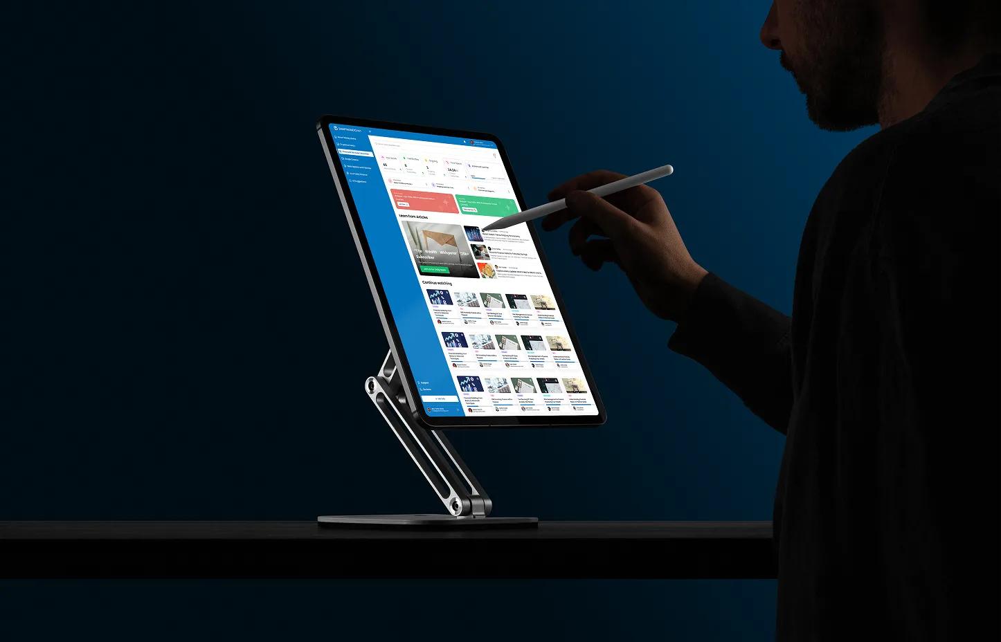 Monitor on an adjustable stand showing the Teacher AI Studio content tools