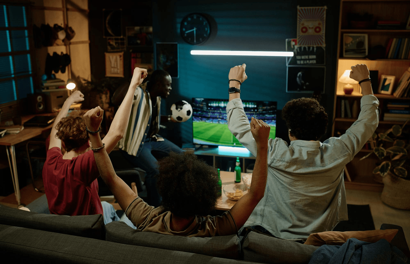 Friends watching football together in a living room
