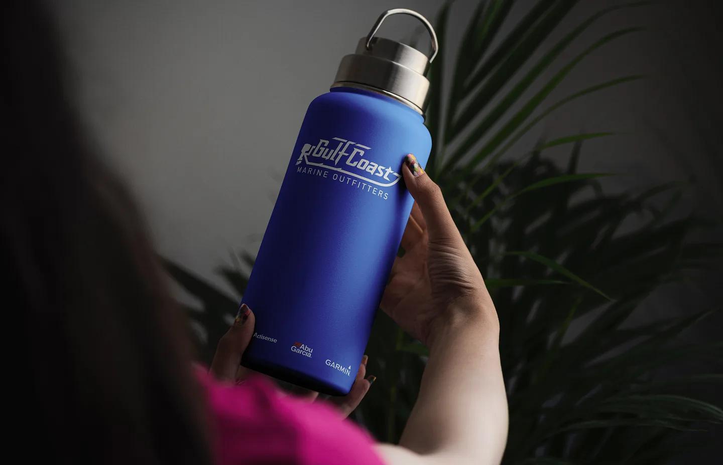 Person holding a Gulf Coast Marine Outfitters branded water bottle