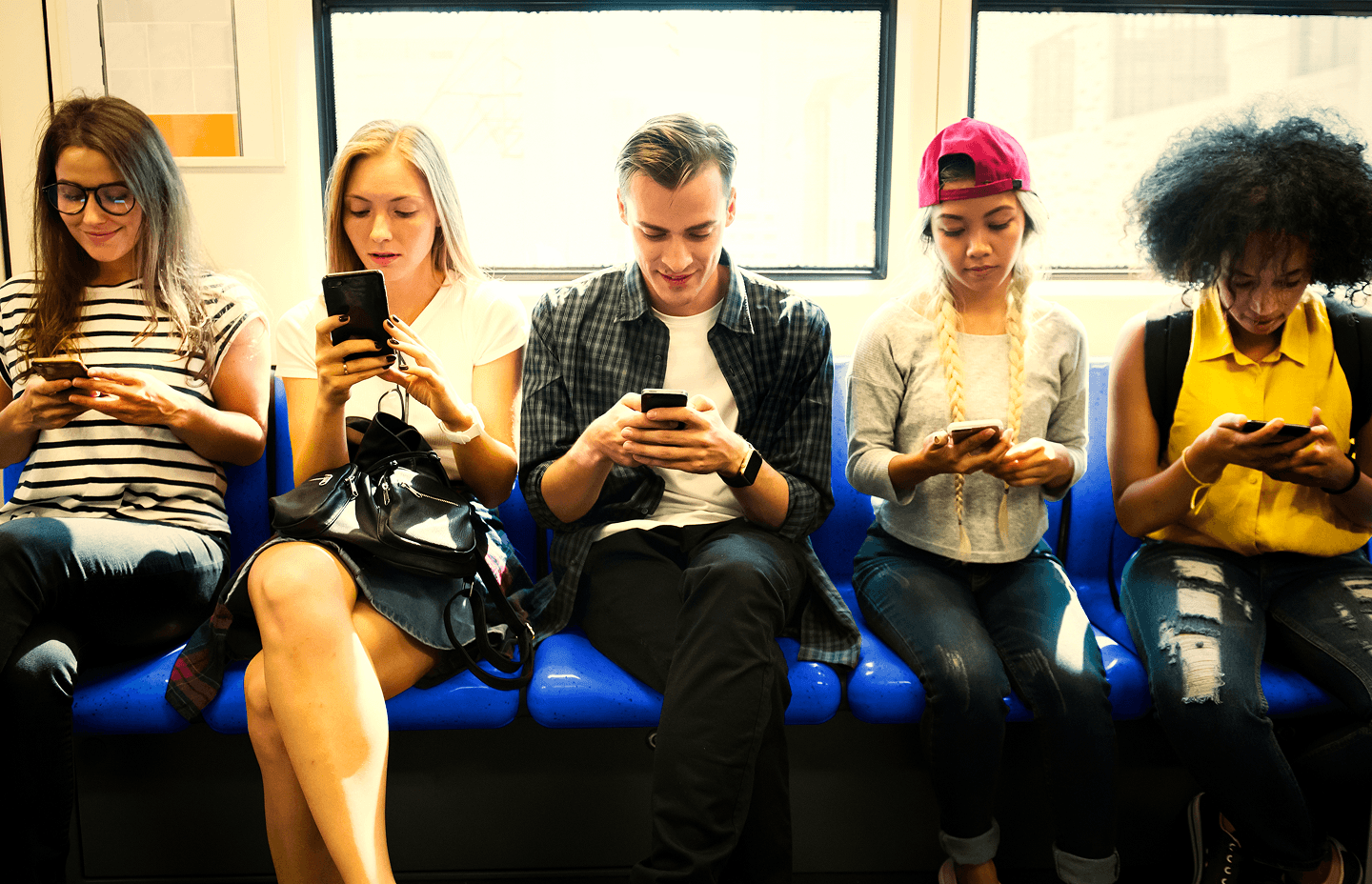 Group of people scrolling social media on their phones
