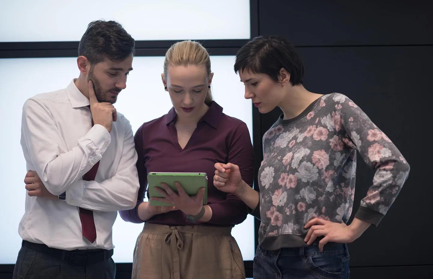 Team reviewing training content together on a tablet