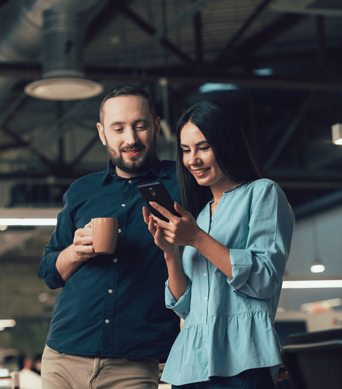 Couple looking at a mobile phone screen together