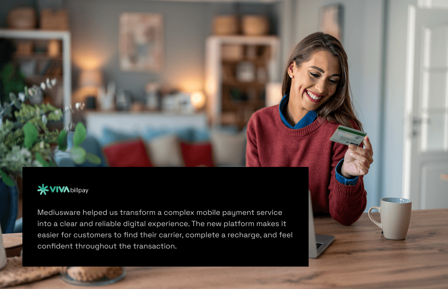 Smiling woman holding credit card and checking payment confirmation