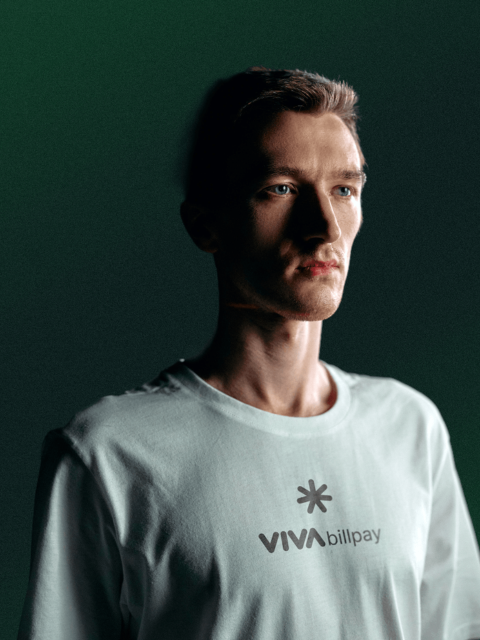 Man wearing a white Viva Bill Pay brand t-shirt